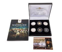 A London Mint Nelson five coin set, including three silver crowns, Alderney 22ct one pound,