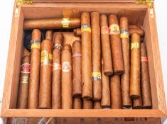 A collection of various cigars in a walnut humidor, including Rome Y Julieta, Bolivar,