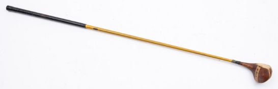 A 20th Century Apollo driver. Having a wooden head with cane shaft and wrapped grip, 107cm long.