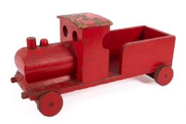 A scratch built wooden toy train. Finished in red with wooden wheels, 23cm high, 51cm long.