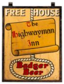 A painted metal advertising sign for 'The Highwayman Inn'.