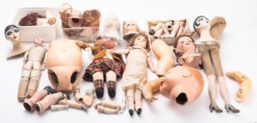 A mixed collection of wooden and porcelain doll parts.