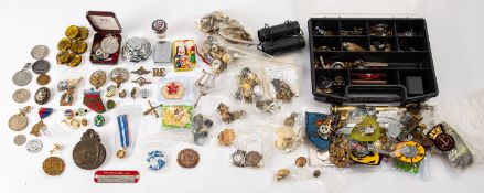 A collection of various military and civil buttons, insignia and cap badges,