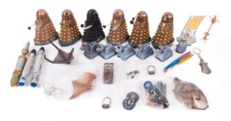 Six battery operated Daleks. Together with models of K-9 and sonic screwdrivers etc.