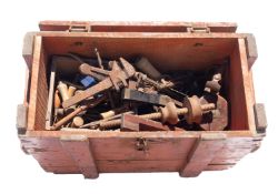 A collection of workshop tools in a wooden crate.