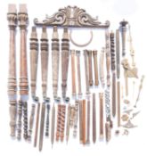 A pair of gilt metal columns together with similar wooden examples.