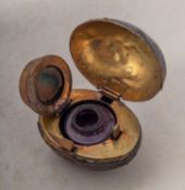 An early 20th century novelty travelling inkwell in the form of a rugby ball,