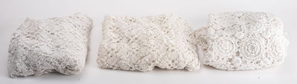 Three crocheted lace table covers.