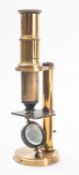 A 19th century brass student microscope, unsigned in a mahogany case with slides:.