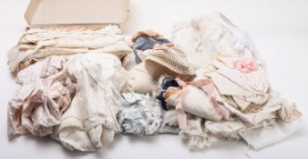 A collection of christening gowns and lace clothing.