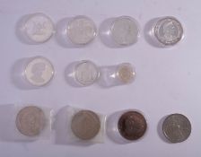 A collection of silver and other crown sized coins.