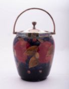 A Walter Moorcroft pottery biscuit barrel tube lined in the Pomegranate pattern,