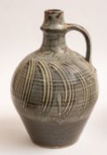 *David Leach [1911-2005] a stoneware ewer with ribbed neck and applied ribbed strap handle with