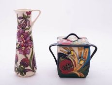 Two pieces of Moorcroft pottery comprising a limited edition two handled square jar and cover tube
