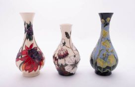 Three Moorcroft pottery vases each of tear drop form and comprising an example tube lined in the