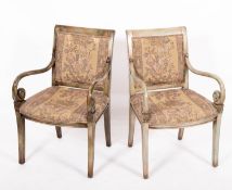 A pair of painted wood and upholstered open elbow chairs in early 19th century taste,