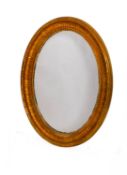 A modern gold painted wood and composition oval wall mirror,