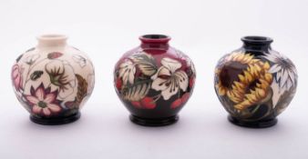 Three small Moorcroft pottery vases of globular form, 11cm high,