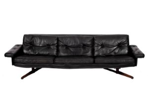 A black leather three piece sofa suite,