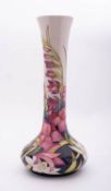 A Moorcroft pottery limited edition vase of squat form with slender waisted neck tube lined in the