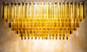 An impressive Continental nickel plated metal and amber glass hung twelve light electrolier,