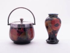 Two pieces of William Moorcroft tube lined in the Pomegranate pattern reserved on a blue ground,
