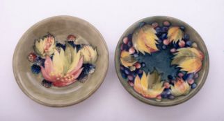 Two Walter Moorcroft pottery plates tube lined in the Grape and Leaf and Blackberry and Leaf