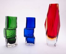 Four coloured art glass vases of varying form together with a glass ashtray.