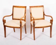 A pair of decorated maple and upholstered open elbow chairs in early 19th century taste,