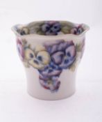 A William Moorcroft pottery vase of swelling cylindrical form with notched rim,