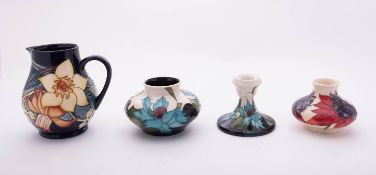 Four pieces of Moorcroft pottery each after designs by Emma Bossons,