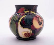 A Moorcroft pottery vase of globular form tube lined in the Queens Choice pattern after a design by