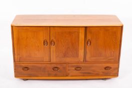 An Ercol blonde elm dining room suite,
