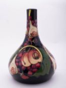 A Moorcroft pottery vase of pear shaped form tube lined in the Queens Choice pattern after a design