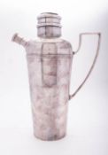A silver plated cocktail shaker, tapering circular form, with a reeded girdle and an angular handle,