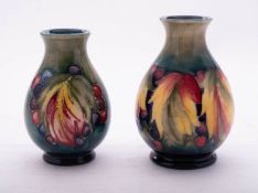 Two Walter Moorcroft pottery vases both of oviform and tube lined in the Leaf and Berry pattern