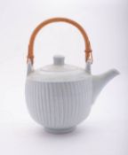 *David Leach [1911-2005] a porcelain teapot and cover with cut decoration under a pale celadon