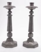 A pair of substantial pewter candlesticks in Arts & Crafts style,