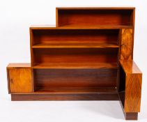 A walnut corner bookcase in Art Deco taste, circa 1930s; with irregular open shelves,