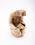 A Vila pottery figure in the form of an Egyptian block carving of a kneeling figure,