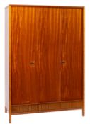 Heal's, London; a teak three door wardrobe,