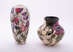 Two Moorcroft pottery vases comprising an oviform example tube lined in the Sweetness pattern after