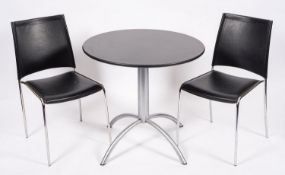 A bistro table and twin chairs, modern; the table with circular polished black granite top
