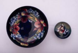 Two William Moorcroft pottery bowls both tube lined in the Orchid pattern,