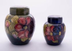 Two Walter Moorcroft pottery oviform jars and covers, both tube lined in the Anemone pattern,