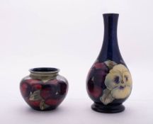 Two William Moorcroft pottery vases both tube lined in the Pansies pattern,