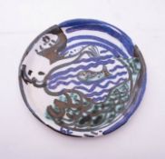*Lydia Corbett [b1934] a stoneware plate: of circular form boldly painted with a mermaid and fish,
