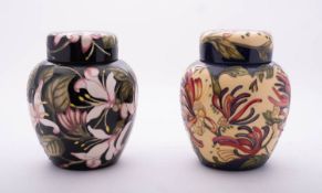 Two Moorcroft pottery jars and covers both oviform comprising one tube lined in the Woodbine