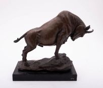 A patinated metal, probably bronze model of a bull,