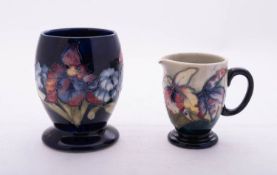 Two pieces of Walter Moorcroft pottery tube lined in the Orchid pattern,